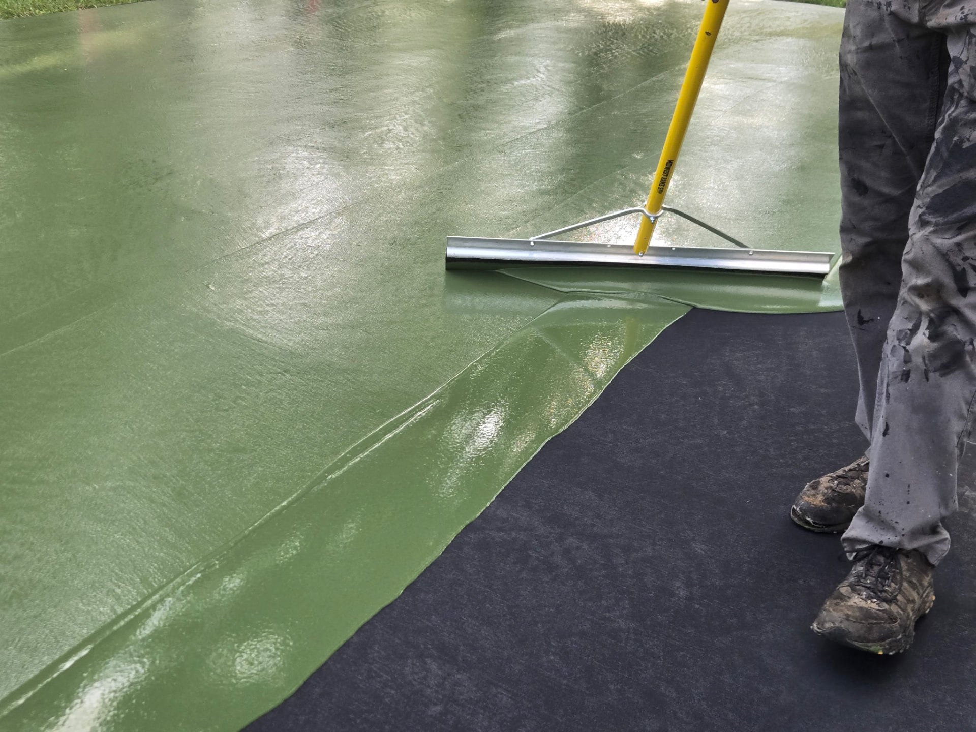 DuraStrate applying a green acrylic court surface